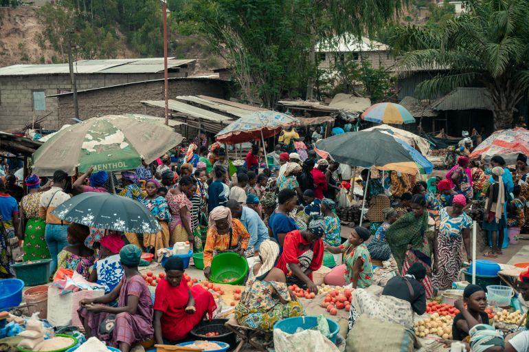 afp_69411d43d4f3-1765875011 Vendors and customers crowd a market in Uvira on December 9, 2025.