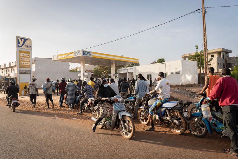 afp_69482dd650bd-1766338006 Motorcyclists line up to get fuel at one of the few petrol stations with supply in Bamako on December 10, 2025.