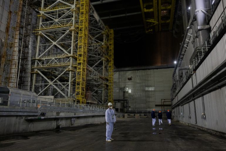 afp_694ab77855ae-1766504312 The station employee stands inside the containment vessel that was damaged following a drone attack on February 14, 2025, on the New Safe Confinement (NSC) which contains the radiation from the remains of reactor 4 of the former Chernobyl Nuclear Power Plant, in Chernobyl, on December 22, 2025, amid the Russian invasion of Ukraine.