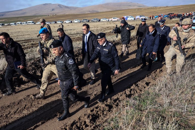 afp_694d398c454e-1766668684 Libyan military delegation members arrive at the wreckage site following the crash of a Libya-bound business jet carrying Libyan Chief of Staff General Muhammad Ali Ahmed Al-Haddad, found 2 kilometers south of Kesikkavak Village at Haymana district in Ankara on December 24, 2025.
