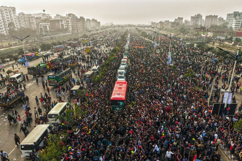 TOPSHOT - An aerial view shows supporters gathered around a convoy carrying Tarique Rahman, son of former prime minister Khaleda Zia and Bangladesh Nationalist Party (BNP)'s acting chairman during a rally after his arrival in Dhaka on December 25, 2025.