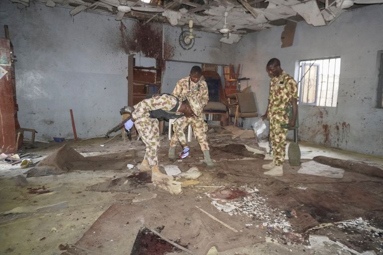 Military personnel inspect the scene of the explosion at a mosque in the Gamboru market in Maiduguri on December 25, 2025.