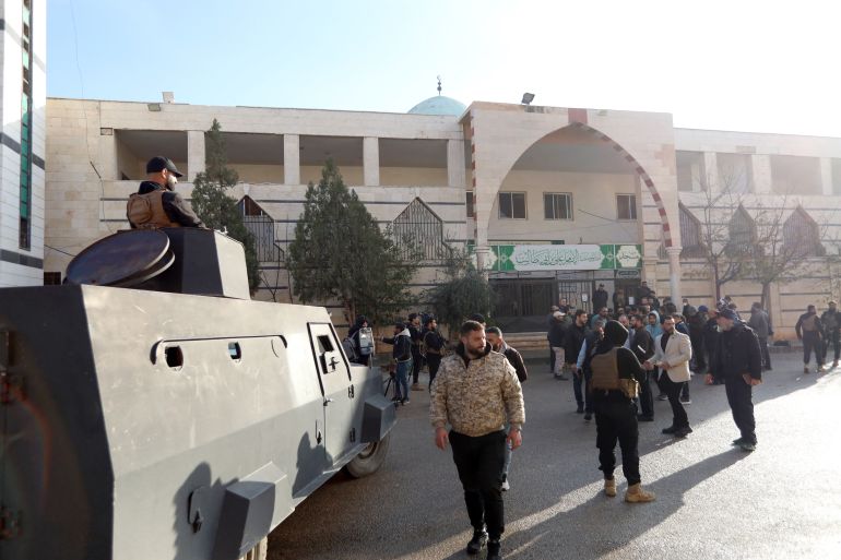 Security officers and members of the press gather outside Imam Ali ibn Abi Talib Mosque following an explosion in the Wadi al-Dahab neighborhood of Homs on December 26, 2025.