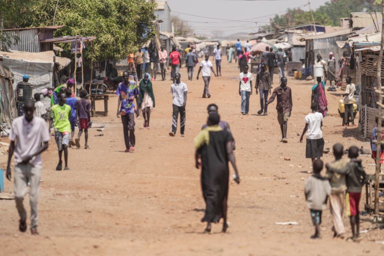 ap_68efa13d7a10f-1760534845 FILE - Internally displaced people walk along a street in Juba, South Sudan, Thursday, Feb. 13, 2025. (AP Photo/Brian Inganga, File)