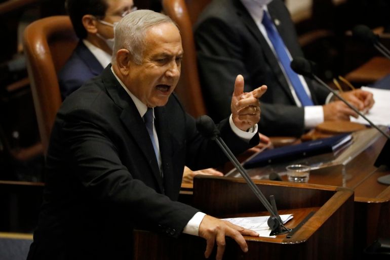 ap_6923f3fb99411-1763963899 FILE - Former Israeli Prime Minister Benjamin Netanyahu speaks during a session of the Knesset, Israel's parliament, in Jerusalem, Monday, Oct. 4, 2021. Netanyahu watched from the sidelines Thursday as the government that toppled him after 12 years in power passed a national budget, dealing a major blow to his hopes of a swift return to the country's top office. (AP Photo/Ariel Schalit, File)