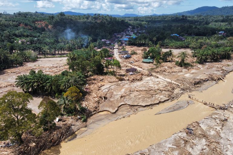 ap_692ff10d5c6af-1764749581 FILE - This aerial photo taken using drone shows a village affected by a flash flood in Batang Toru, North Sumatra, Indonesia, on Dec. 1, 2025. (AP Photo/Binsar Bakkara, File)