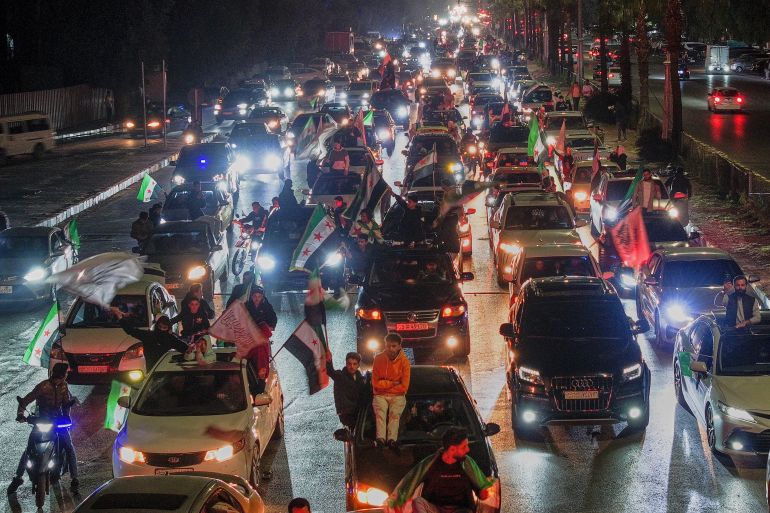 Syrians celebrate the first anniversary of the ousting of the Bashar Assad regime in Damascus, Syria, early Saturday, Dec. 6, 2025. (AP Photo/Ghaith Alsayed)