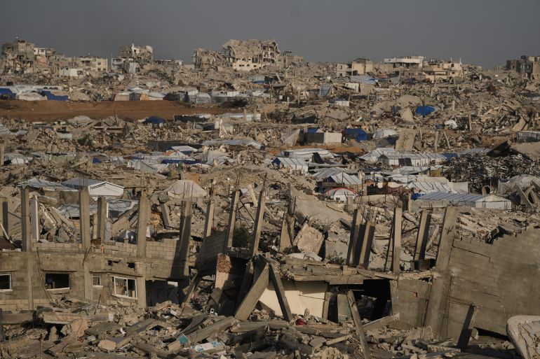 ap_69368c2a77d93-1765182506-1 Tents are scattered among the widespread destruction in Jabalia, in the northern Gaza Strip, Sunday, Dec. 7, 2025. (AP Photo/Jehad Alshrafi)