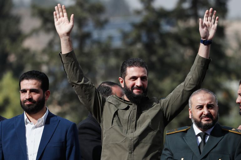 Syria's interim president, Ahmad al-Sharaa, greets people as he attends celebrations marking the first anniversary of the ousting of former President Bashar Assad in Damascus, Syria, Monday, Dec. 8, 2025. (AP Photo/Omar Sanadiki) I