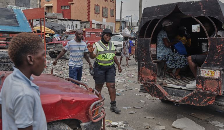 ap_6939472da2a2b-1765361453 Police patrol an intersection in Port-au-Prince, Haiti, Wednesday, Oct. 1, 2025. (AP Photo/Patrice Noel)