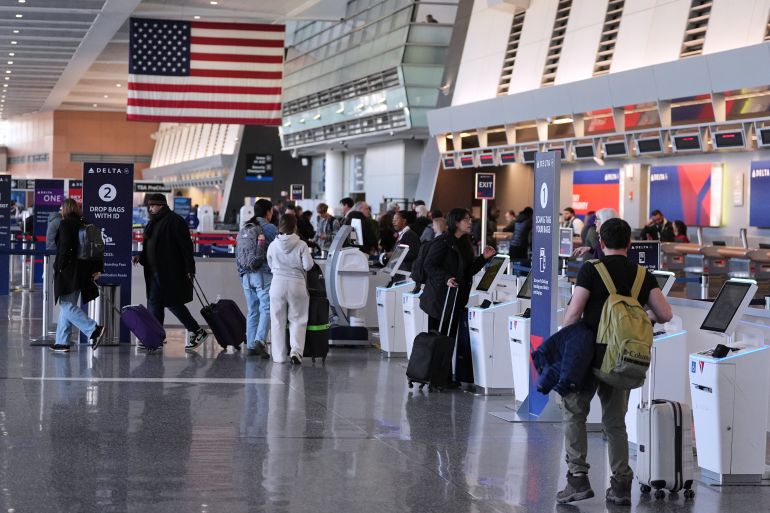 ap_693d79e4c7969-1765636580 Travelers walk through Terminal A at Logan Airport, Tuesday, Dec. 9, 2025, in Boston. (AP Photo/Charles Krupa)