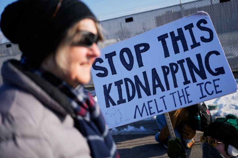 Protesters gather as Law enforcement officers guard outside an ICE processing facility in the Chicago suburb of Broadview, Ill., Friday, Dec. 12, 2025. (AP Photo/Nam Y. Huh)