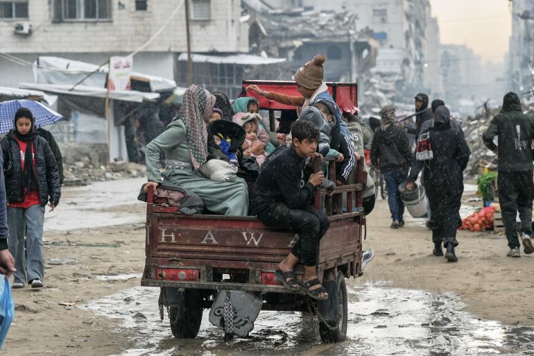 ap_694106f975146-1765869305 A Palestinian family rides on a cart amid the rain in Gaza City, Monday, Dec. 15, 2025. (AP Photo/Jehad Alshrafi)