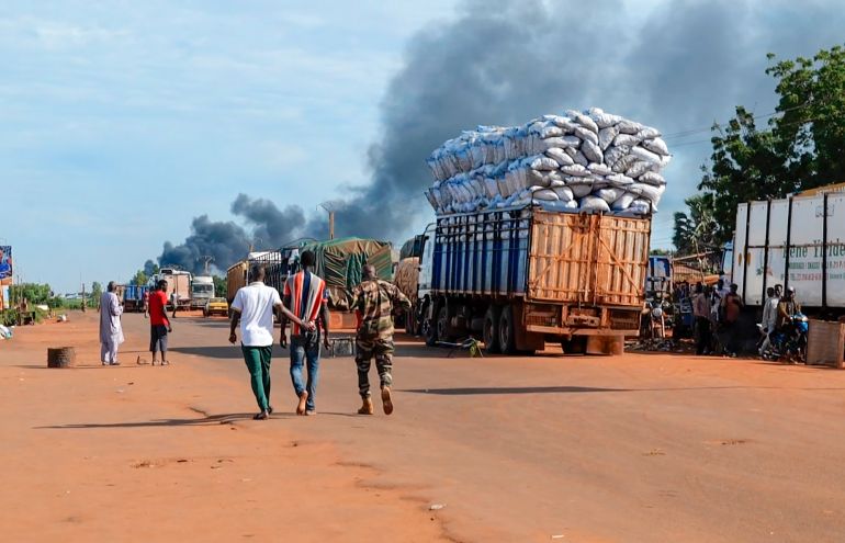 ap_69482e154af76-1766338069 This video grab shows Malian security personnel detaining a man after Mali's army said a military training camp in the capital Bamako has been attacked early Tuesday, Sept. 17 2024. (AP Photo)