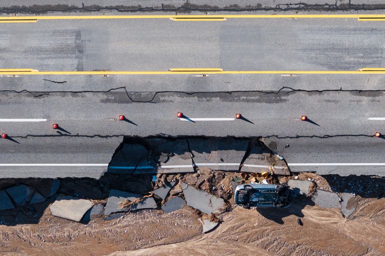 ap_694db305060de-1766699781 An aerial view shows damage to highway 138 after a series of storms on Thursday, Dec. 25, 2025, near Phelan, Calif. (AP Photo/William Liang)