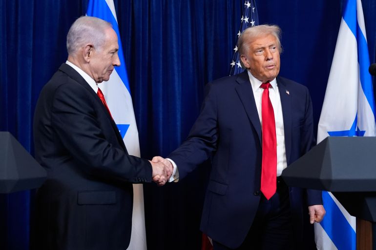 ap_6953003c106b9-1767047228-1 President Donald Trump shakes hands with Israel's Prime Minister Benjamin Netanyahu as he listens to a question from a reporter at the end of a news conference at Mar-a-Lago, Monday, Dec. 29, 2025, in Palm Beach, Fla. (AP Photo/Alex Brandon)