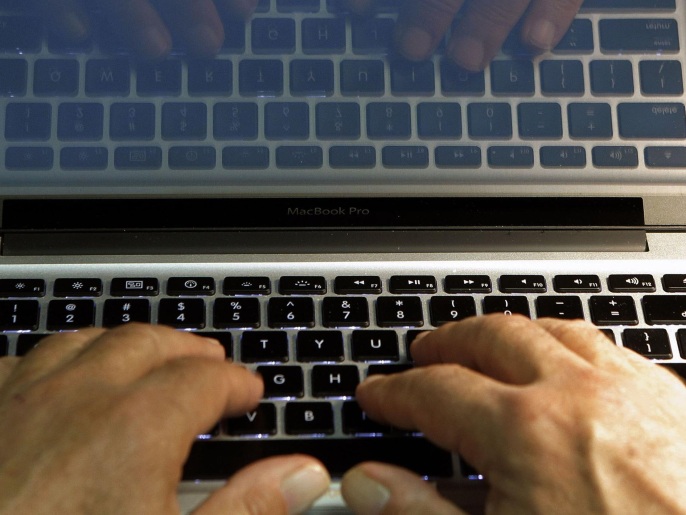 FILE - In this Feb. 27, 2013, file photo illustration, hands type on a computer keyboard in Los Angeles. Tech experts agree that traditional passwords are annoying, outmoded and too easily hacked. Yahoo and Microsoft are offering new log-in solutions via text, facial recognition and fingerprint-identification technology. (AP Photo/Damian Dovarganes, File)