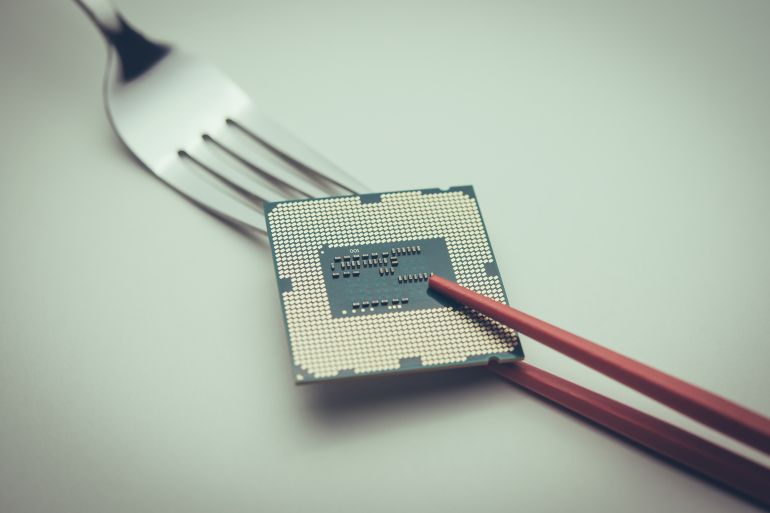 d9826d8bad8a7d981d8a8d984-1763312450 US fork and Chinese chopsticks fighting over CPU on white background. US vs China chip war or tech war, microchip semiconductor industrial concept. US restrict and control chip export to China. by pla2na ادوبي ستوك
