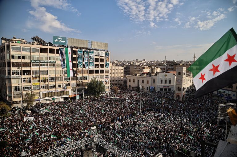 epa12572446 A general view shows hundreds of people gathered in Al-Assi Square during celebrations marking one year since the city’s liberation, in Hama, Syria, 05 December 2025. Syria marks the first anniversary of the sudden collapse of Bashar al-Assad's regime on 08 December 2025, bringing to an end more than five decades of Baathist rule. According to the UN Human Rights Office, the civil war in Syria claimed more than 300.000 civilians' lives from March 2011 to March 2021. Millions of Syrians remain displaced inside the country and as refugees abroad. EPA/BILAL AL-HAMMOUD