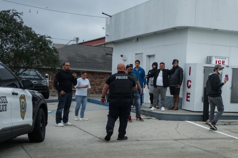 epa_693a50e4ced5-1765429476 epa12576064 Residents confront a Kenner Police Department officer over the department’s collaboration with US Border Patrol after an immigration detention in Kenner, Louisiana, USA, 06 December 2025. About 250 federal Border Patrol agents have been deployed to New Orleans and surrounding areas as part of the Trump administration's ongoing crackdown on undocumented immigration. EPA/OLGA FEDOROVA