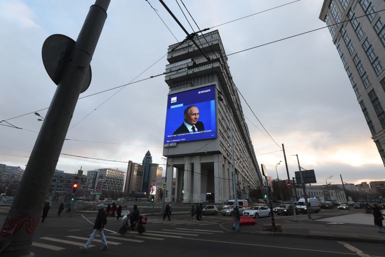 epa12603165 A giant screen displays a live broadcast of the Russian President Vladimir Putin's annual press conference, in Moscow, Russia, 19 December 2025. Russian President Vladimir Putin on 19 December holds his end-of-year press conference and the 'Direct Line with Vladimir Putin' televised event, where he will answer citizens' questions focusing on domestic issues. EPA/MAXIM SHIPENKOV