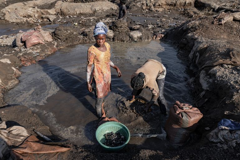 getty_6931155d04-1764824413 KOLWEZI, DEMOCRATIC REPUBLIC OF CONGO - MAY 26: Two teenage girls work inside a narrow pit at an artisanal cobalt and copper mine on May 26, 2025 in Kolwezi, Democratic Republic of Congo. (Photo by Michel Lunanga/Getty Images)