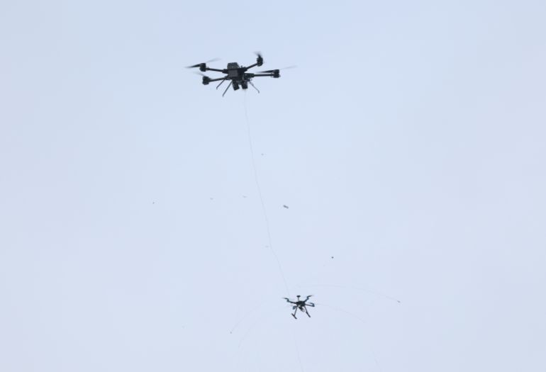 AHRENSFELDE, GERMANY - DECEMBER 02: An Argus Interception GmbH interceptor drone intercepts another drone with a net during a demonstration at the inauguration of the new German federal police anti-drone unit on December 02, 2025 in Ahrensfelde, Germany. Germany has experienced a number of drone fly-overs at military bases, critical infrastructure and airports over recent months. Both federal and state governments are seeking to create both a legal framework and technical capabilities for countering the threat. (Photo by Sean Gallup/Getty Images)