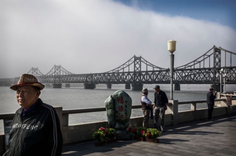 getty_694e4b5a33-1766738778 DANDONG, CHINA - MAY 24: (CHINA OUT) Chinese men walk on the boardwalk near the "Friendship Bridge" in the border city of Dandong, Liaoning province, northern China across from the city of Sinuiju, North Korea on May 24, 2017 in Dandong, China. China has long been North Korea's main ally and trading partner, but relations are increasingly strained by continued missile testing and provocations by the regime of Kim Jong Un. The North is almost entirely dependent on trade with China to feeds its impoverished economy, yet it has ignored calls by the international community to halt its nuclear and ballistic missile weapons programs. At least three-quarters of trade between the two nations flows through points along its 880-mile long shared border, a divide that reveals stark contrasts in development. Cities such as Dandong boast high-rise buildings and advanced infrastructure, and the Friendship Bridge serves as the conduit for the bulk of trade. From hired boats along the Yalu river, Chinese tourists peer into the reclusive North, marked by soldiers, meagre villages, and depleted farmland. The United States has pressured China to do more to leverage its clout with North Korea, though Beijing remains concerned that outright regime collapse in Pyongyang could trigger a rush of refugees across the border. (Photo by Kevin Frayer/Getty Images)