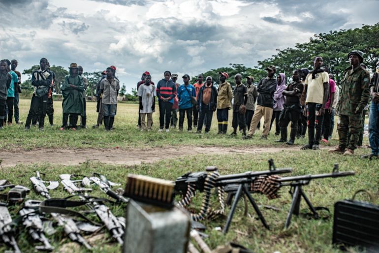 UVIRA, DEMOCRATIC REPUBLIC OF CONGO - DECEMBER 15: Wazalendo militants huddle near their weapons surrendered to members of the Rwanda-backed M23 rebel group on December 15, 2025 in Uvira, Democratic Republic of Congo. Fifty-two members from the coalition of Congolese and Burundian militias known as the Wazalendo joined M23 following the rebels' capture of the South Kivu city on December 10. Human Rights Watch has reported abuses perpetrated against civilians by fighters from both sides of the conflict during the offensive on Uvira, and has called for the safe passage and humanitarian assistance for those caught up in the fighting. (Photo by Daniel Buuma/Getty Images)