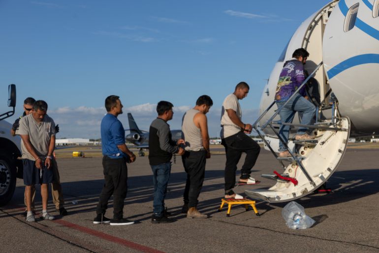 migration-ice-1765635337 Immigrants in detainment shackles, deemed eligible for an expedited order of removal, board air transport by the U.S. Immigration and Customs Enforcement (ICE) at an airport in Tampa, Florida, U.S., November 7, 2025. REUTERS/Shannon Stapleton