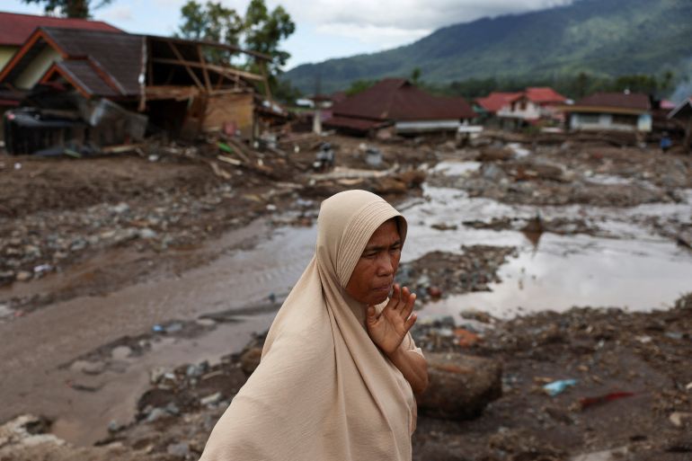 reuters_69300184-1764753796 A woman reacts as she visits an area hit by deadly landslides following heavy rains in Malalak, Agam regency, West Sumatra province, Indonesia, December 3, 2025. REUTERS/Willy Kurniawan