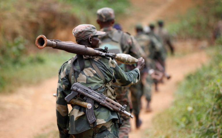 reuters_69311372-1764823922 FILE PHOTO: Democratic Republic of Congo military personnel (FARDC) patrol against the Allied Democratic Forces (ADF) and the National Army for the Liberation of Uganda (NALU) rebels near Beni in North-Kivu province, December 31, 2013. The Democratic Republic of Congo is struggling to emerge from decades of violence and instability, particularly in its east, in which millions of people have died, mostly from hunger and disease. A 21,000-strong United Nations peacekeeping mission (MONUSCO) is stationed in the country. REUTERS/Kenny Katombe/File Photo