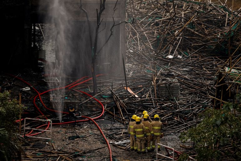 Firefighters gather next to bamboo scaffolding debris at the Wang Fuk Court housing complex after the deadly fire, in Tai Po, Hong Kong, China, December 1, 2025. REUTERS/Maxim Shemetov TPX IMAGES OF THE DAY SEARCH