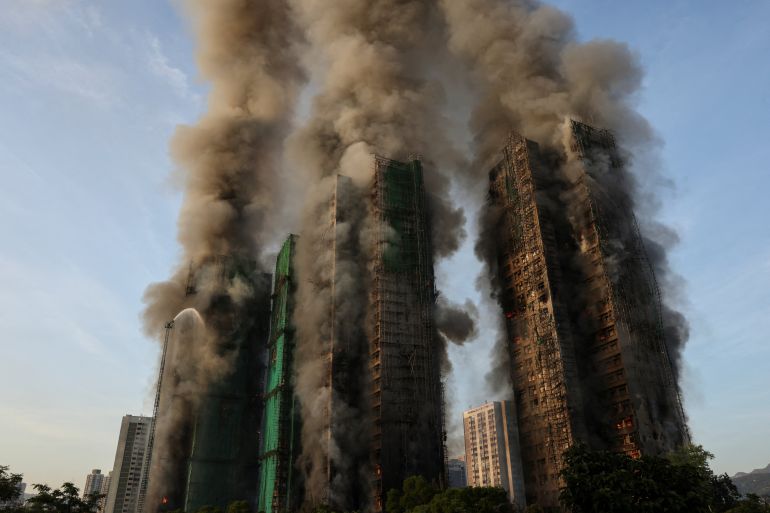 A general view shows flames and thick smoke rising from multiple residential blocks at the Wang Fuk Court housing complex during a deadly fire, in Tai Po, Hong Kong, China, November 26, 2025. REUTERS/Tyrone Siu SEARCH