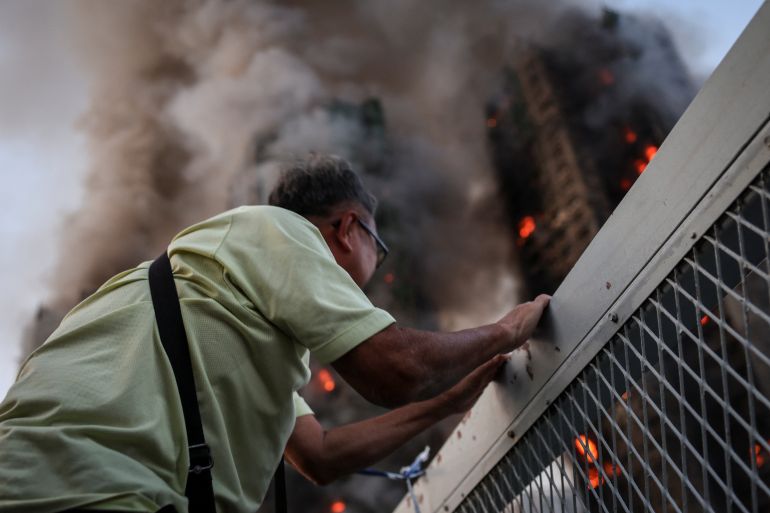 Wong, 71, reacts after saying his wife is trapped inside Wang Fuk Court during a major fire, in Tai Po, Hong Kong, China, November 26, 2025. REUTERS/Tyrone Siu SEARCH
