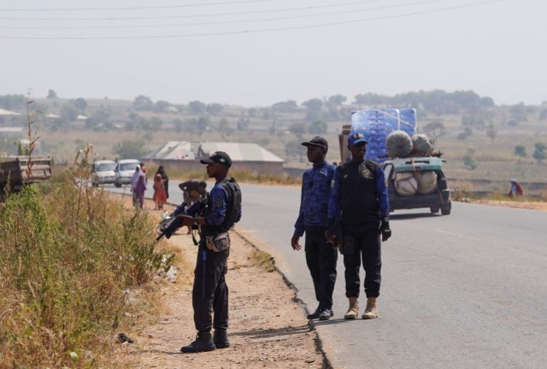 reuters_6936a4b7-1765188791-1 Members of the Civilian Joint Task Force (CJTF) stand guard during a drill near a bush in Minna, Niger State, Nigeria, November 29, 2025. Vigilante groups have stepped in to fill security gaps as rural communities face rising attacks and abductions by armed gangs. REUTERS/Marvellous Durowaiye