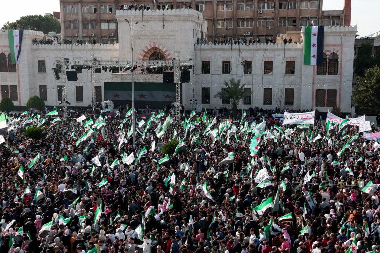 FILE PHOTO: Residents of Hama gather during a protest to mark the first anniversary of the fall of Bashar al-Assad's regime, in Hama, Syria December 5, 2025. REUTERS/Mahmoud Hassano/File Photo