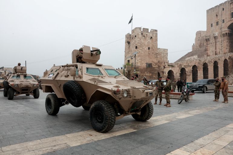 Syrian army members take part in a military parade, as they mark the first anniversary of Bashar al-Assad's fall, in Aleppo, Syria December 8, 2025. REUTERS/Mahmoud Hassano