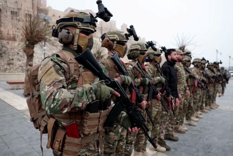 Syrian army members take part in a military parade, as they mark the first anniversary of Bashar al-Assad's fall, in Aleppo, Syria December 8, 2025. REUTERS/Mahmoud Hassano