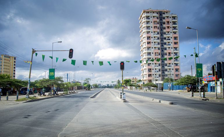 reuters_69383d12-1765293330 Flags of Tanzania's ruling Chama Cha Mapinduzi Party (CCM) hang displayed near a street light along a deserted street during the 64th Independence Day under a lockdown imposed by the government to counter planned anti-government protests against deadly violence during demonstrations around the October elections, in Dar es Salaam, Tanzania, December 9, 2025. REUTERS/Emmanuel Herman