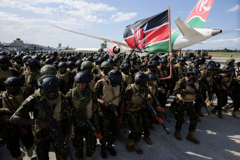 reuters_69394579-1765361017 Kenyan police officers line up after disembarking in Haiti to join an expanded multinational force with a mandate to fight gangs, at Toussaint Louverture International Airport, in Port-au-Prince, Haiti December 8, 2025. REUTERS/Jean Feguens Regala