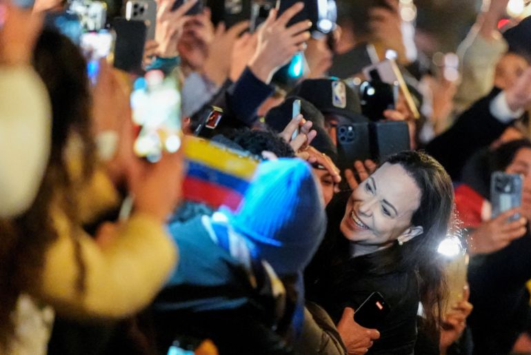 reuters_693a7000-1765437440 Nobel Peace Prize laureate Maria Corina Machado greets supporters outside the Grand Hotel in Oslo, Norway December 11, 2025. NTB/Lise Aserud via REUTERS ATTENTION EDITORS - THIS IMAGE WAS PROVIDED BY A THIRD PARTY. NORWAY OUT. NO COMMERCIAL OR EDITORIAL SALES IN NORWAY.