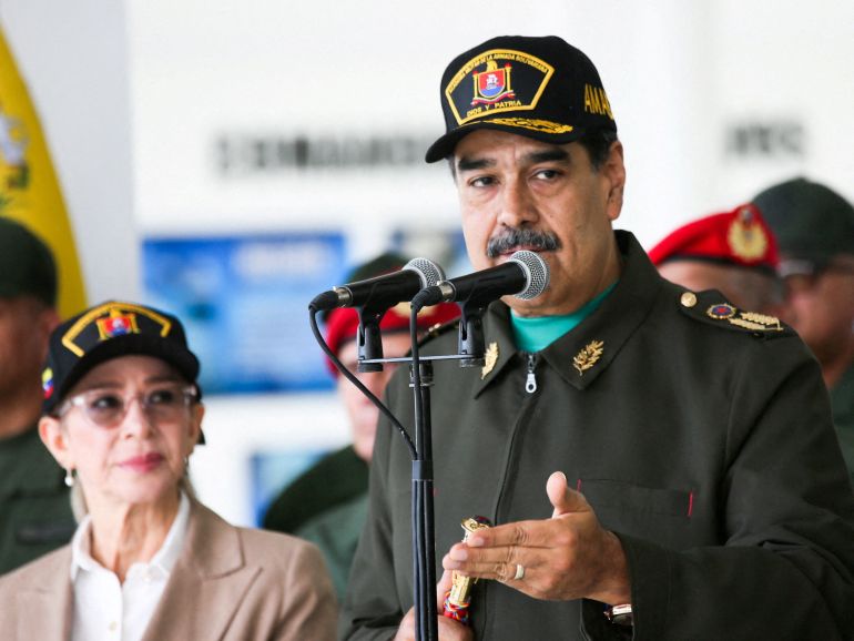 Venezuela’s President Nicolas Maduro and his wife Cilia Flores attend a year-end salutation to military forces in La Guaira, Venezuela December 28, 2025. Miraflores Palace/Handout via REUTERS ATTENTION EDITORS - THIS IMAGE HAS BEEN SUPPLIED BY A THIRD PARTY