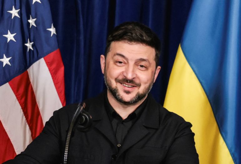 Ukrainian President Volodymyr Zelenskiy smiles after U.S. President Donald Trump said that Russian President Vladimir Putin expressed willingness to help Ukraine "succeed", during a press conference at Trump's Mar-a-Lago club, in Palm Beach, Florida, U.S., December 28, 2025. REUTERS/Jonathan Ernst TPX IMAGES OF THE DAY