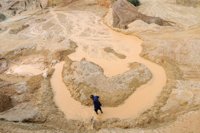 A labourer works at the site of a rare earth metals mine at Nancheng county, Jiangxi province