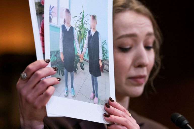 united-nations-2-1764870201 FILE PHOTO: Kateryna Rashevska, a legal expert at the Regional Center for Human Rights (Kyiv, Ukraine), holds pictures she says depict abducted Ukrainian children as she testifies before a U.S. Senate Appropriations subcommittee hearing on the abduction of Ukrainian children by the Russian Federation on Capitol Hill in Washington, D.C., U.S., December 3, 2025. REUTERS/Jonathan Ernst/File Photo