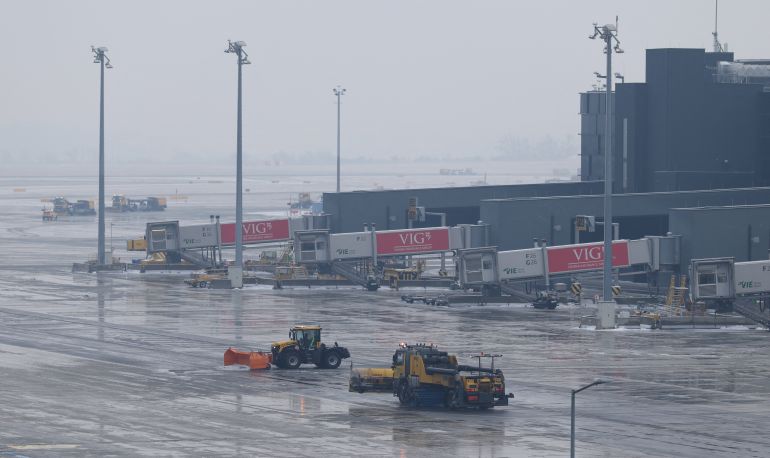 Snowplows drive on the tarmac of Vienna International Airport (VIE), in Schwechat, Austria, January 13, 2026. REUTERS/Leonhard Foeger