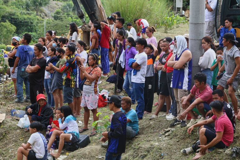 2phill-1767937729 Relatives and others wait for updates after a huge mound of garbage collapsed at a waste segregation facility in Binaliw, Cebu city on Friday, Jan. 9, 2026. (AP Photo/Jacqueline Hernandez)