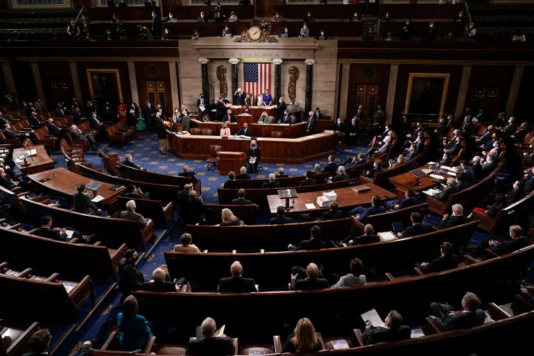 FILE - In this Jan. 6, 2021, photo, the Republican side, right, in the House chamber is seen as Speaker of the House Nancy Pelosi, D-Calif., and Vice President Mike Pence officiate as a joint session of the House and Senate convenes to count the Electoral College votes cast in November's election, at the Capitol in Washington. State attorneys general and the House committee investigating the Jan. 6 attack on the Capitol are digging deeper into the role that fake slates of electors played in the desperate effort by former President Donald Trump to cling to power after his defeat in the 2020 election. (AP Photo/J. Scott Applewhite, Pool, File)