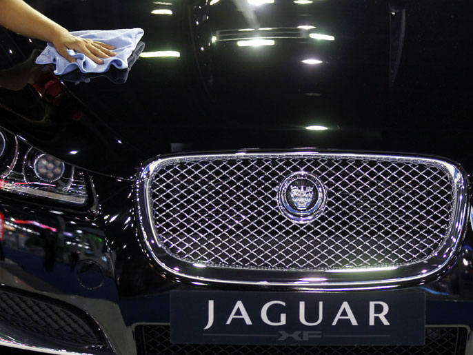 epa03166190 A Thai worker polishes a Jaguar luxury car at the 33rd Bangkok International Motor Show in Bangkok, Thailand, 27 March 2012. The show is open for public from 28 March to 08 April 2012 featuring the future of automobiles through the large number of concept vehicles being displayed. The show is expected to attract more than 1.7 million visitors this year with automakers launching their new products manufactured under the auspices of the governments ecologically-friendly car project and aimed to pull the auto industries back from its crisis caused by the devastating 2011 floods. EPA/RUNGROJ YONGRIT